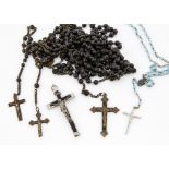 A collection of rosaries, ebony, brass and base metal 140cm long and others