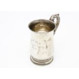 A George V silver tankard, footed bulbous form with applied leaf to handle, engraved B.P.G.C