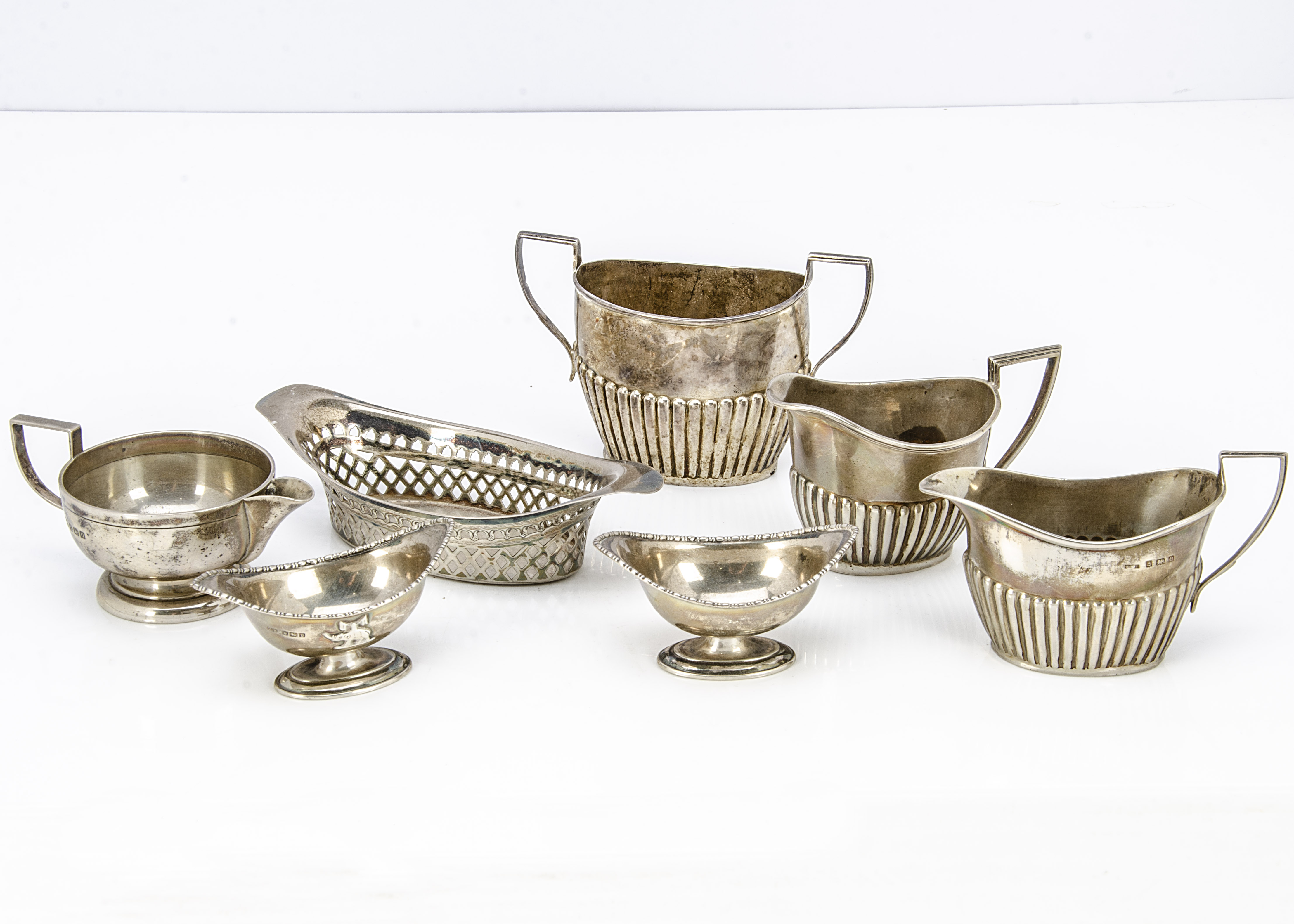 Seven Victorian and later items of silver, including a pierced dish, sugar basin, three milk and