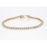 An 18ct yellow gold diamond line bracelet, the seventy brilliant cuts in claw settings, 18.5cm long,