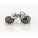 A pair of Black opal ear studs, of oval cabochon cut in claw settings with post backs stamped 925