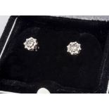 A pair of illusion set diamond ear studs, in white metal, 0.14ct total diamond weight, post backs