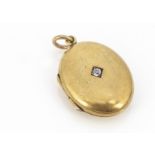 An Edwardian oval 15ct gold and diamond oval locket, 3cm x 1.8cm, marked 15ct in three lozenge mark,