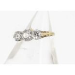 A three stone diamond ring, the old cuts in claw setting on a yellow metal shank marked PLAT and