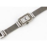 An Art Deco 18ct gold and diamond dress watch, of rectangular form with guilloche enamel face,