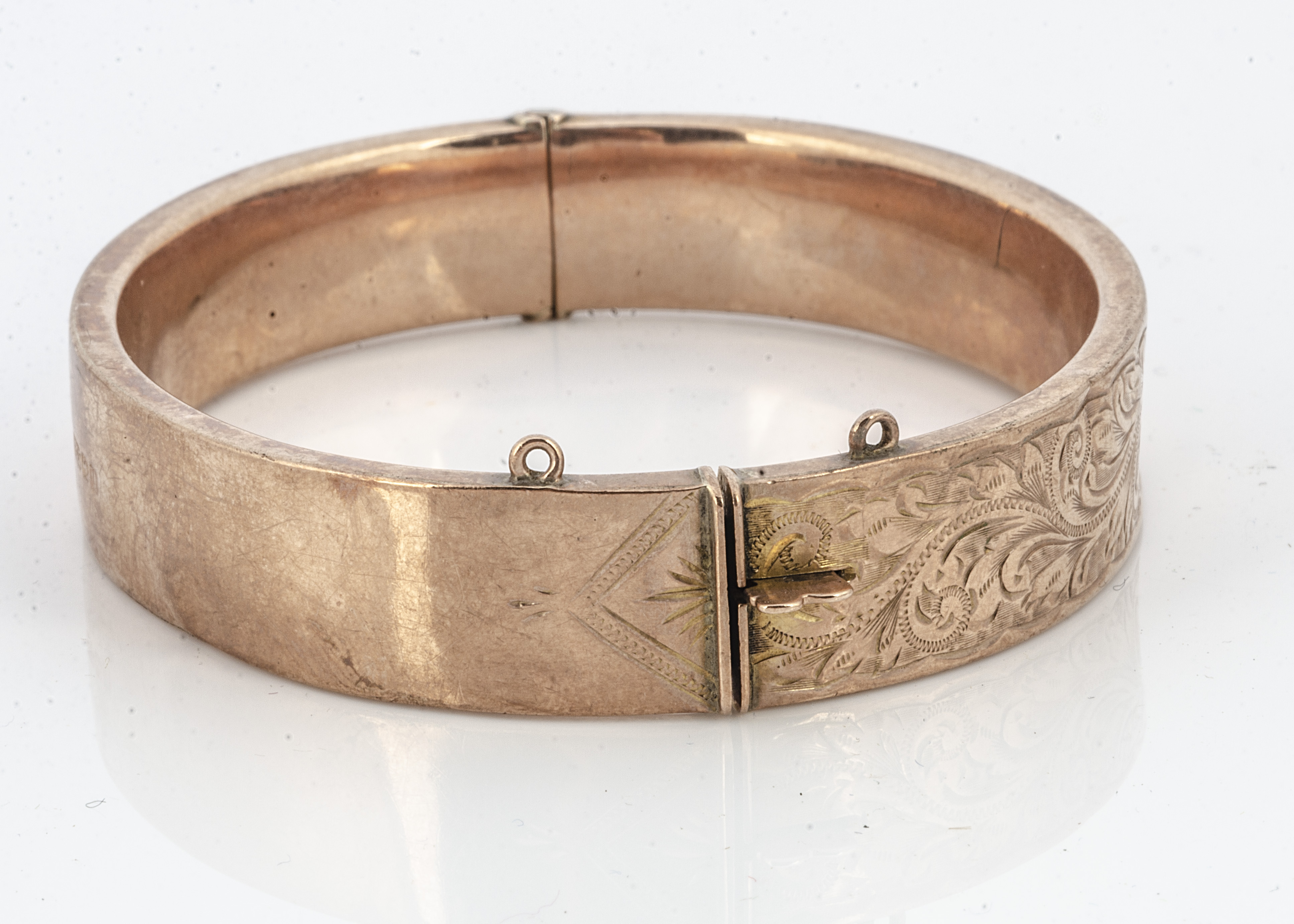 A 9ct gold hinged bangle, with engraved floral decoration, 6cm x 5.2cm internal measurement, 17.2g - Image 2 of 2