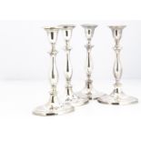 A set of four 19th Century Sheffield silver plated candlesticks, oval bases, some wear and copper