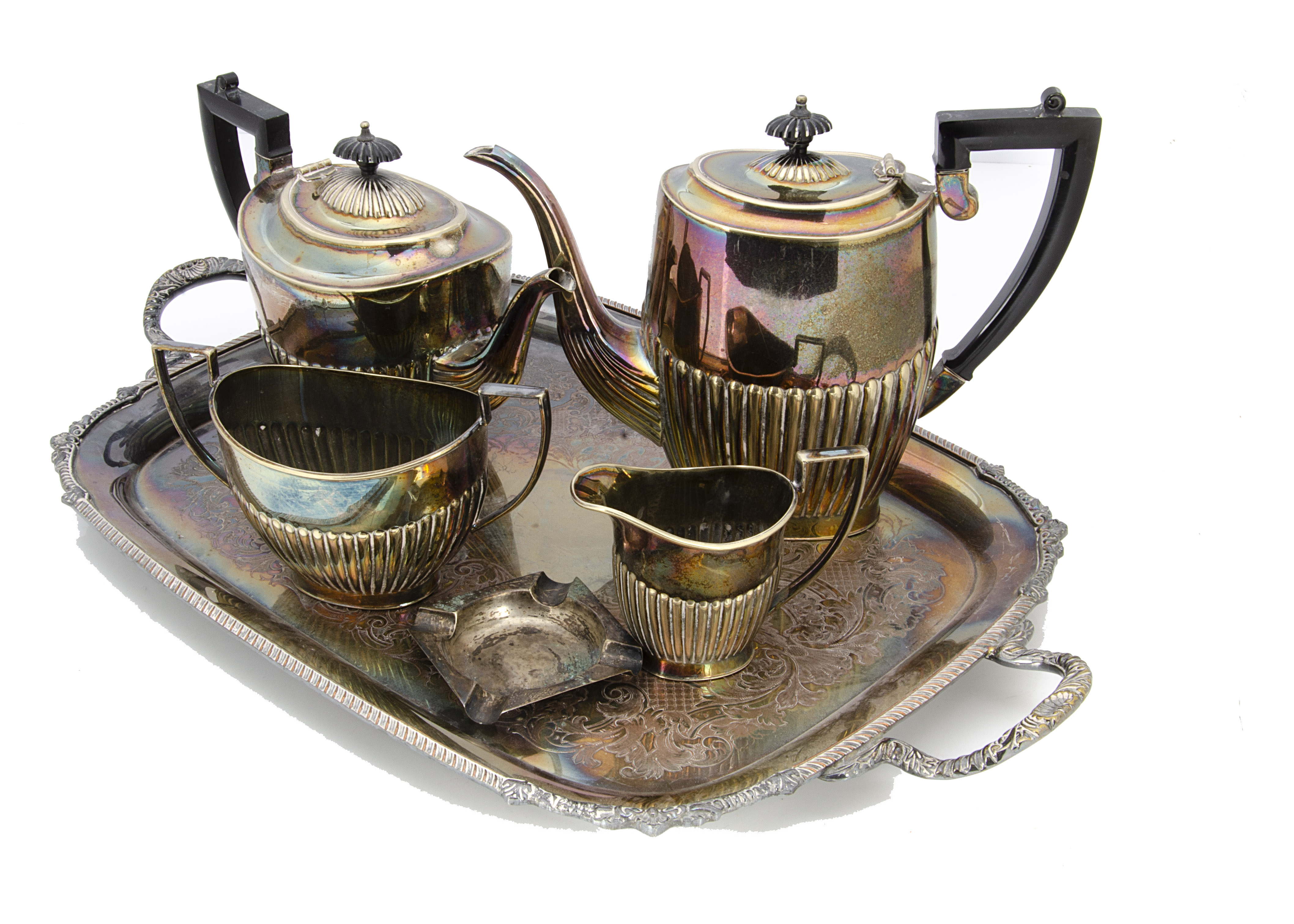 A collection of silver plate, including a twin handled tray, four piece tea set, sugar scuttle,