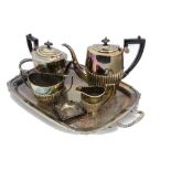 A collection of silver plate, including a twin handled tray, four piece tea set, sugar scuttle,