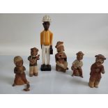 A collection of terracotta South American figurines, together with a wooden carved figure of a South