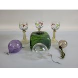 Three Art Nouveau wine glasses, with floral painted bowls on conical twisted stems, together with