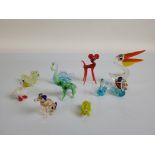 A collection of Murano glass miniature figurines, including models of penguins, scottie dogs,