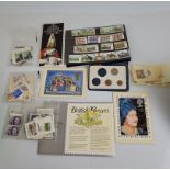 A card cased 1983 United Kingdom £1 coin, a packet of first decimal coins and a small collection