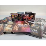 A collection of Xena Warrior Princess memorabilia, including Season 1-6 DVD sets, a collection of
