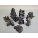 A collection of Inuit carved sculptures, by The Wolf Sculptures, depicting seals, otters, Innuits