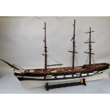 A large wooden ship model, with stand approx 95cm tall x 150cm long.
