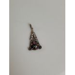 An Arts and Crafts silver and glass drop pendant, of triangular shape with pierced leaf floral