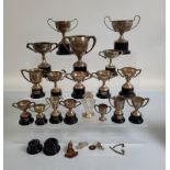 A quantity of silver plated trophies, on black plastic bases