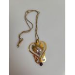 A 9ct gold Art Nouveau amethyst drop pendant, the flattened open work with leaf design mixed cut