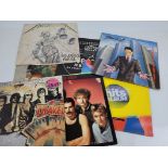 A collection of assorted vinyl LPs, mostly classic rock including Kiss, Metallica, AC DC, Joe Walsh,