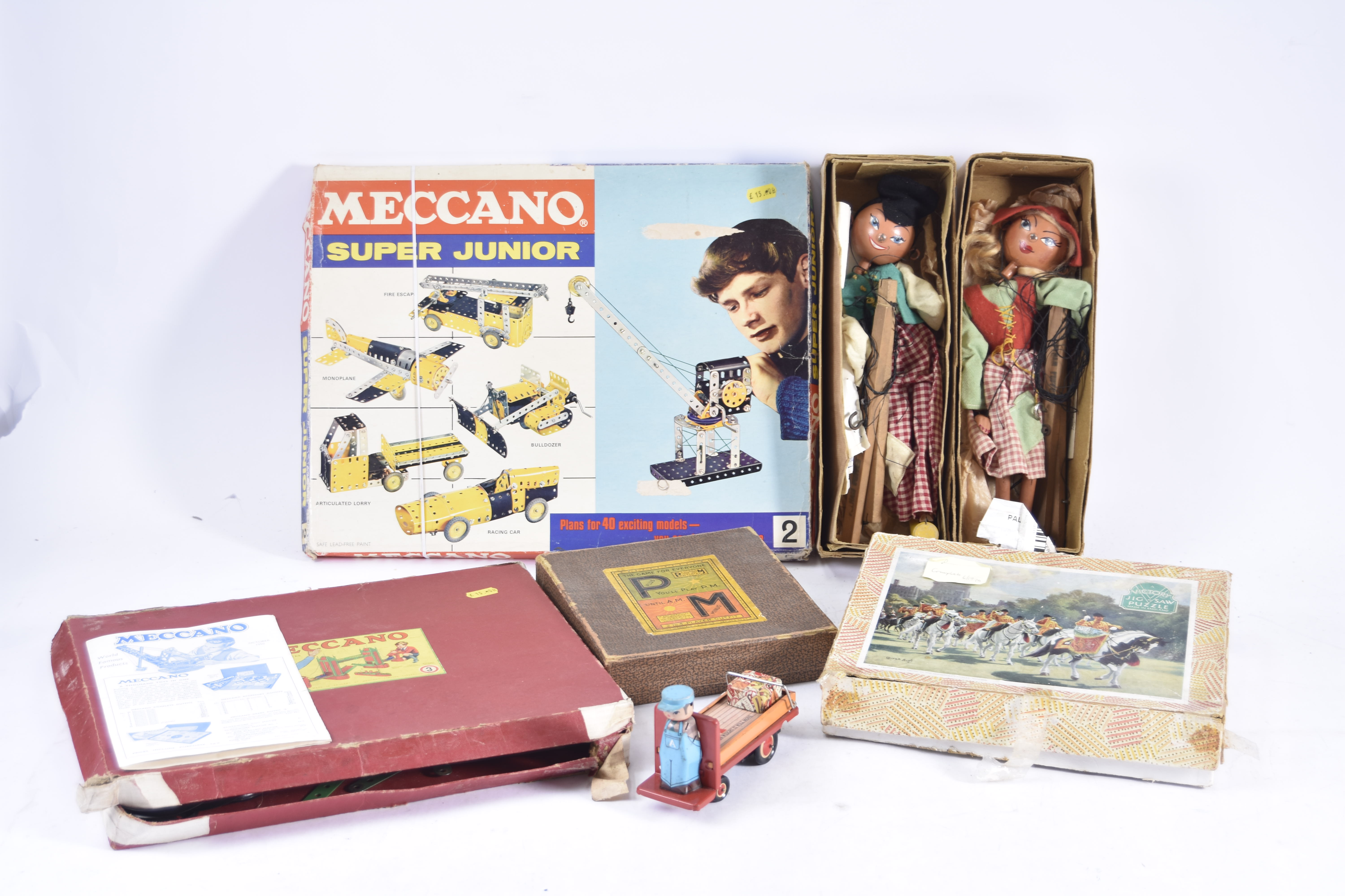 Various Toys including Tin Porters Trolley Jigsaw Meccano Pelham Puppets and other items, modern