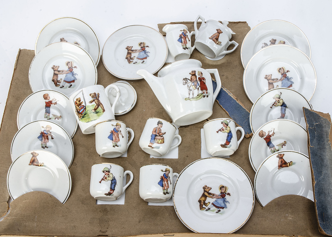 A Continental child's tea set with teddy bears and children, comprising teapot, sugar basin, milk