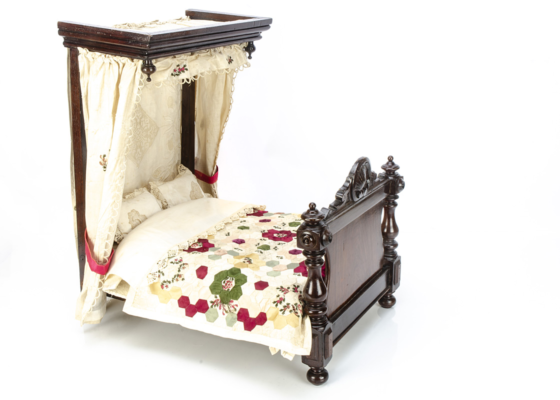 A late 19th century half-tester bed, with 18th century silk curtains, bedding including a