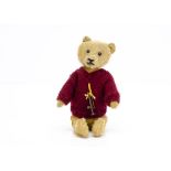 Small a German 1920s teddy bear, with short golden mohair, black painted tinplate eyes, pronounced