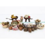 Eleven miniscule artist bears by Tammy Paulick, all seated in an object and with tags --1in. (2.