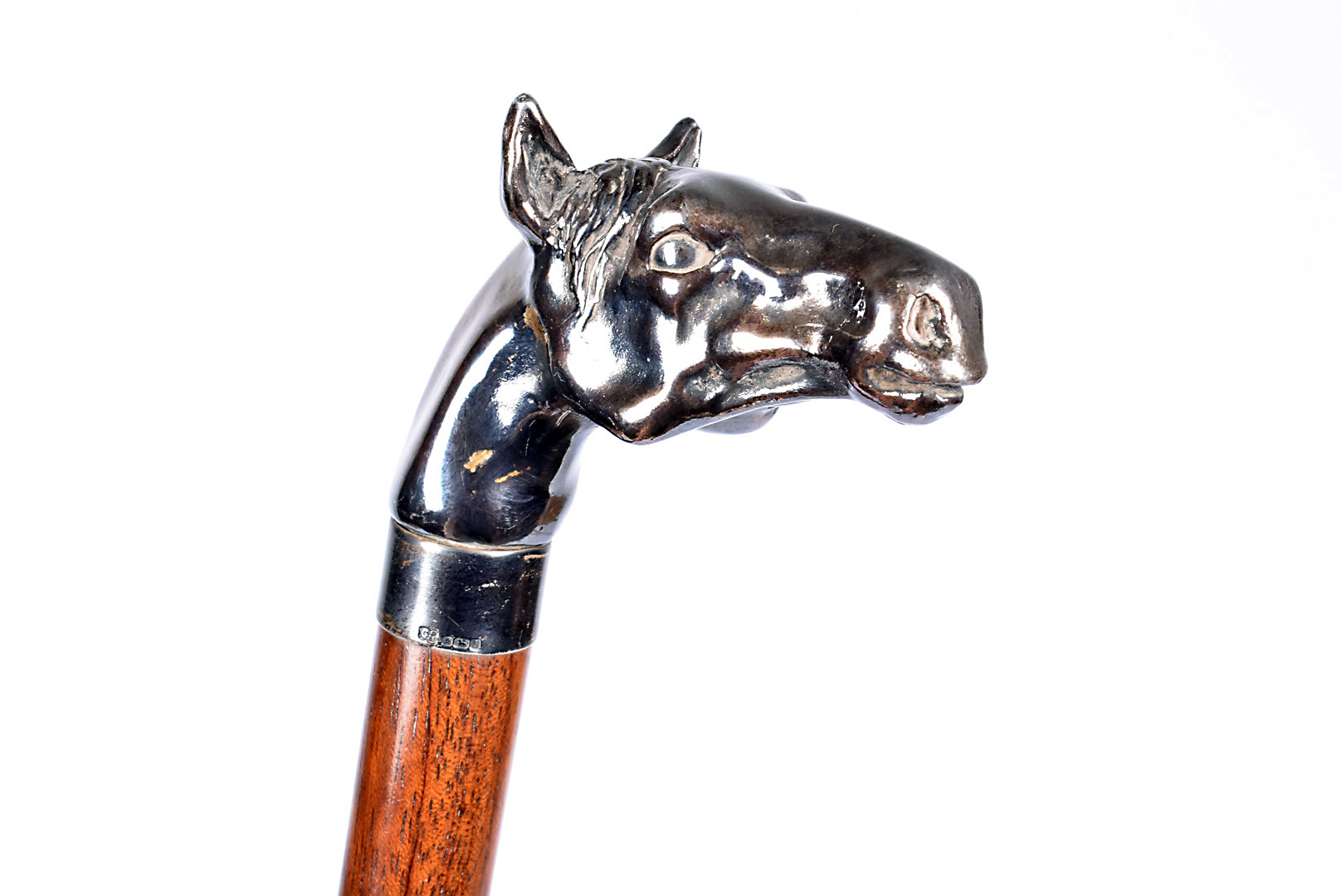 A silver plated horse head walking stick, the top in the form of a horse's head, leading down to