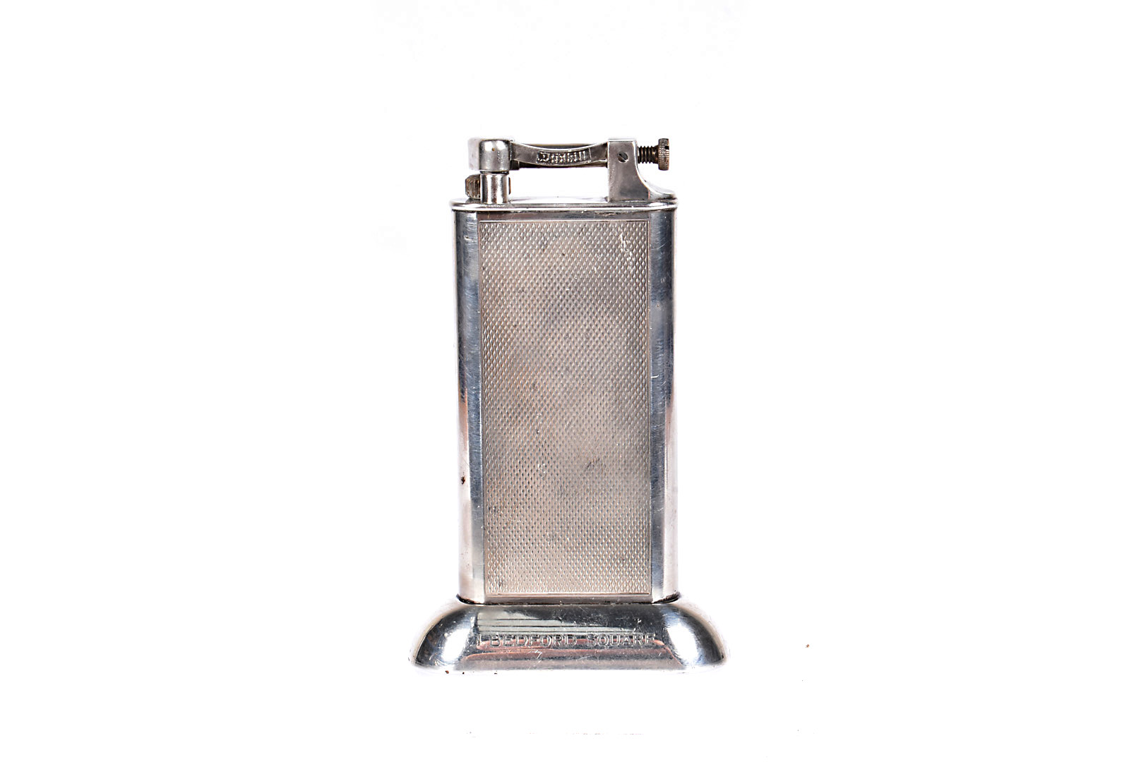 A Dunhill Standard silver plated table lighter, having engine turned design to front and rear,