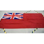 A large Red Ensign flag, stamped 3YD Red Ensign, approximately 276cm x 125cm