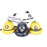 A group of 1960s Firefighter helmets, all from the same person 'Purvey' from the London Fire