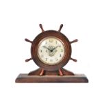 An Ingraham eight day mantle clock, in the form of a ship's wheel, on plinth, 24cm x 29cm