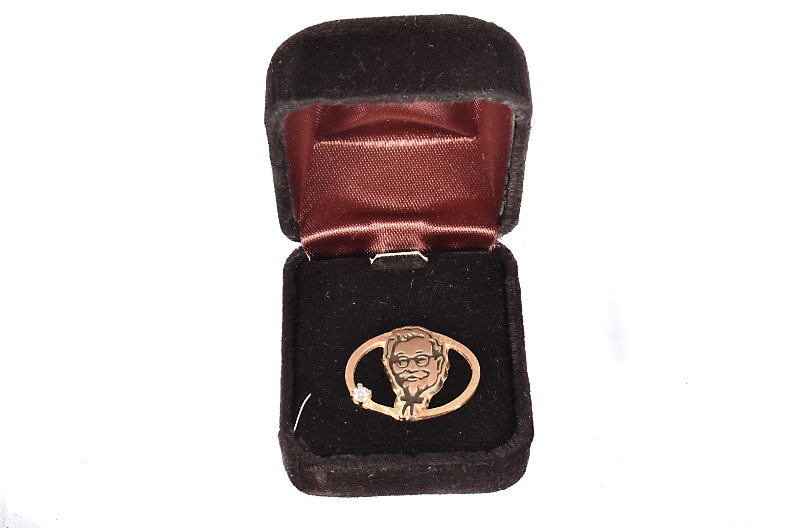 A Kentucky Fried Chicken 14k and diamond badge, marked 14k to reverse, with single round cut