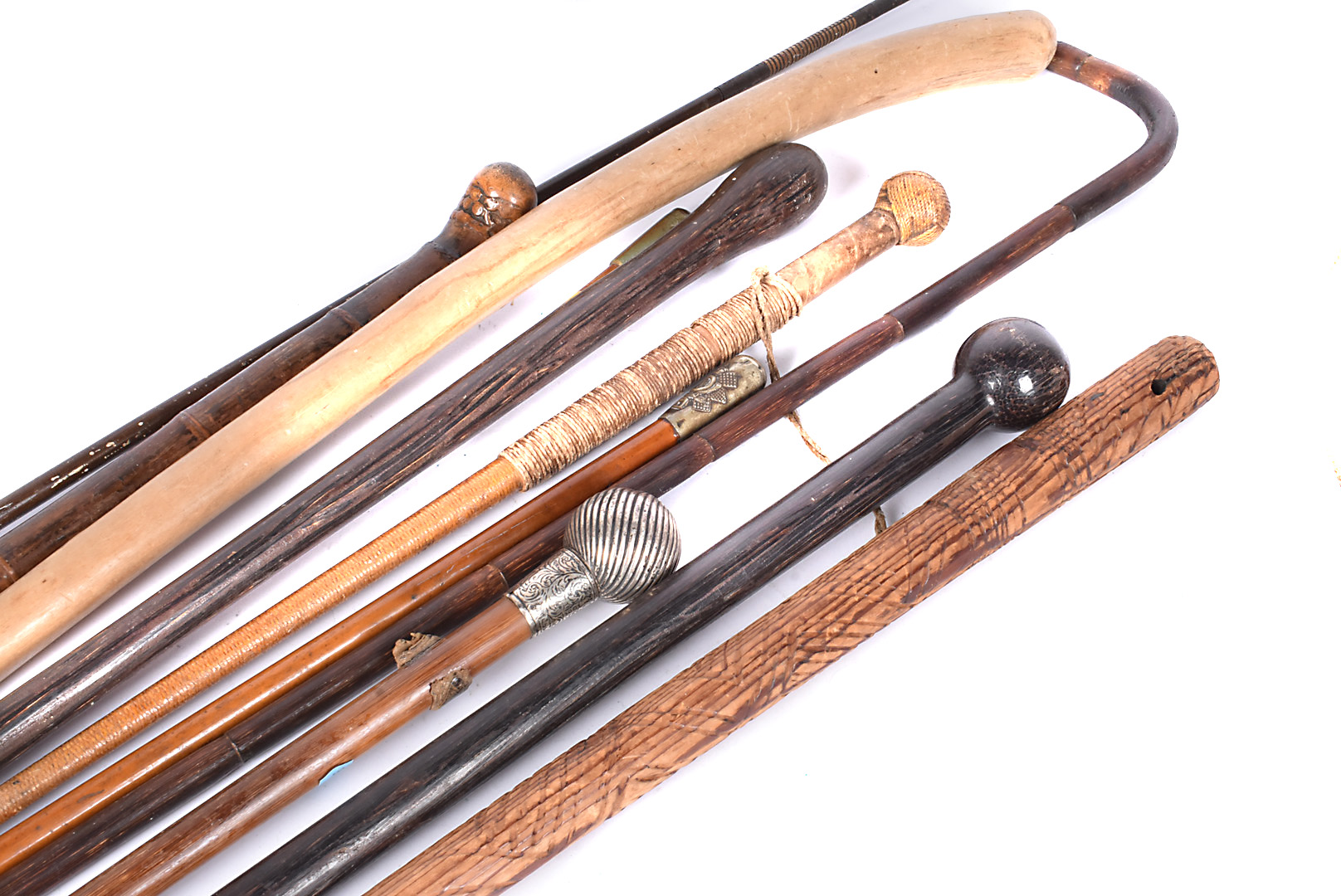 A selection of walking sticks and canes, to include a white metal topped example, a regimental