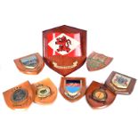 A collection of wooden military plaques, comprising Clan Line Steamers, Royal Air Force Station