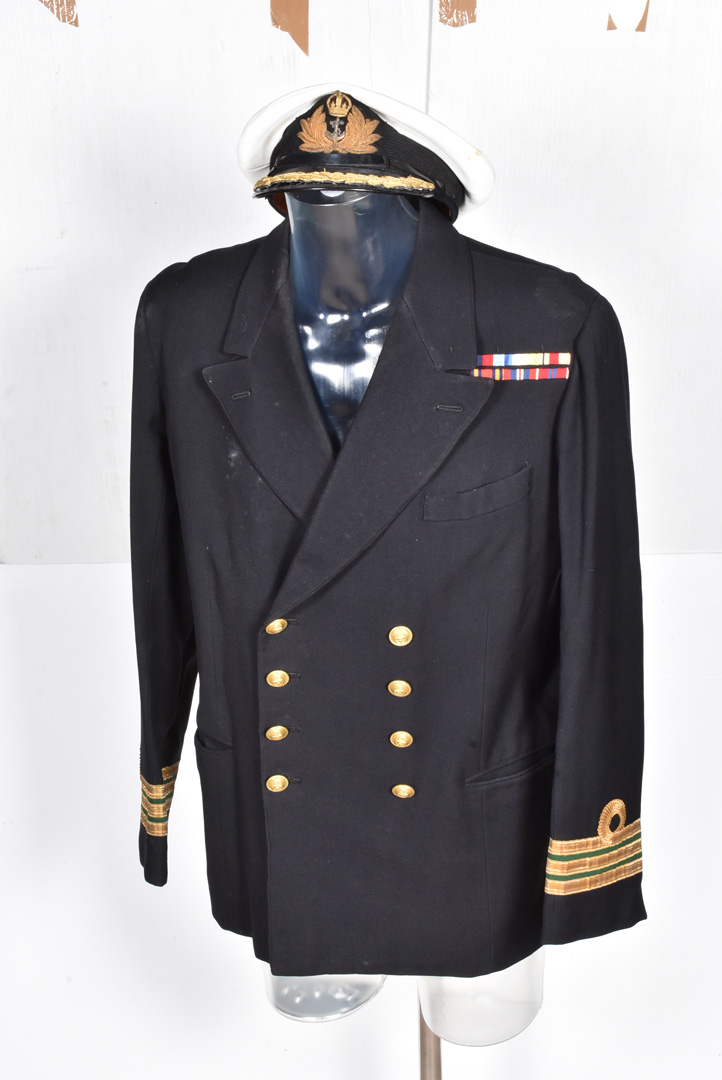 A Naval Commander's Uniform, comprising Jacket, with medal ribbons and badges, trousers, a cap by