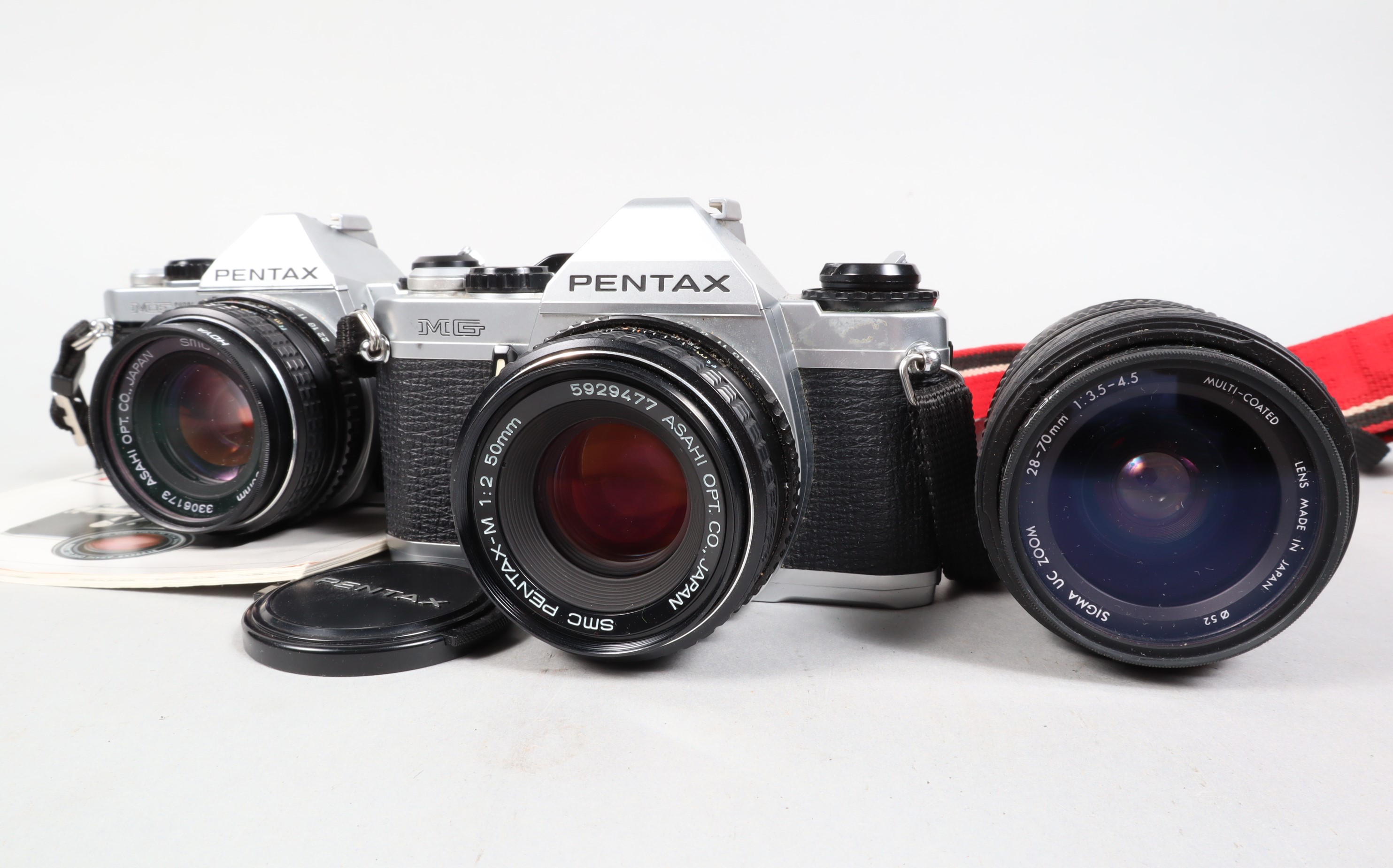 Two Pentax SLR Cameras, a Pentax MG, shutter working, meter responsive, body G, with SMC 50mm f/2