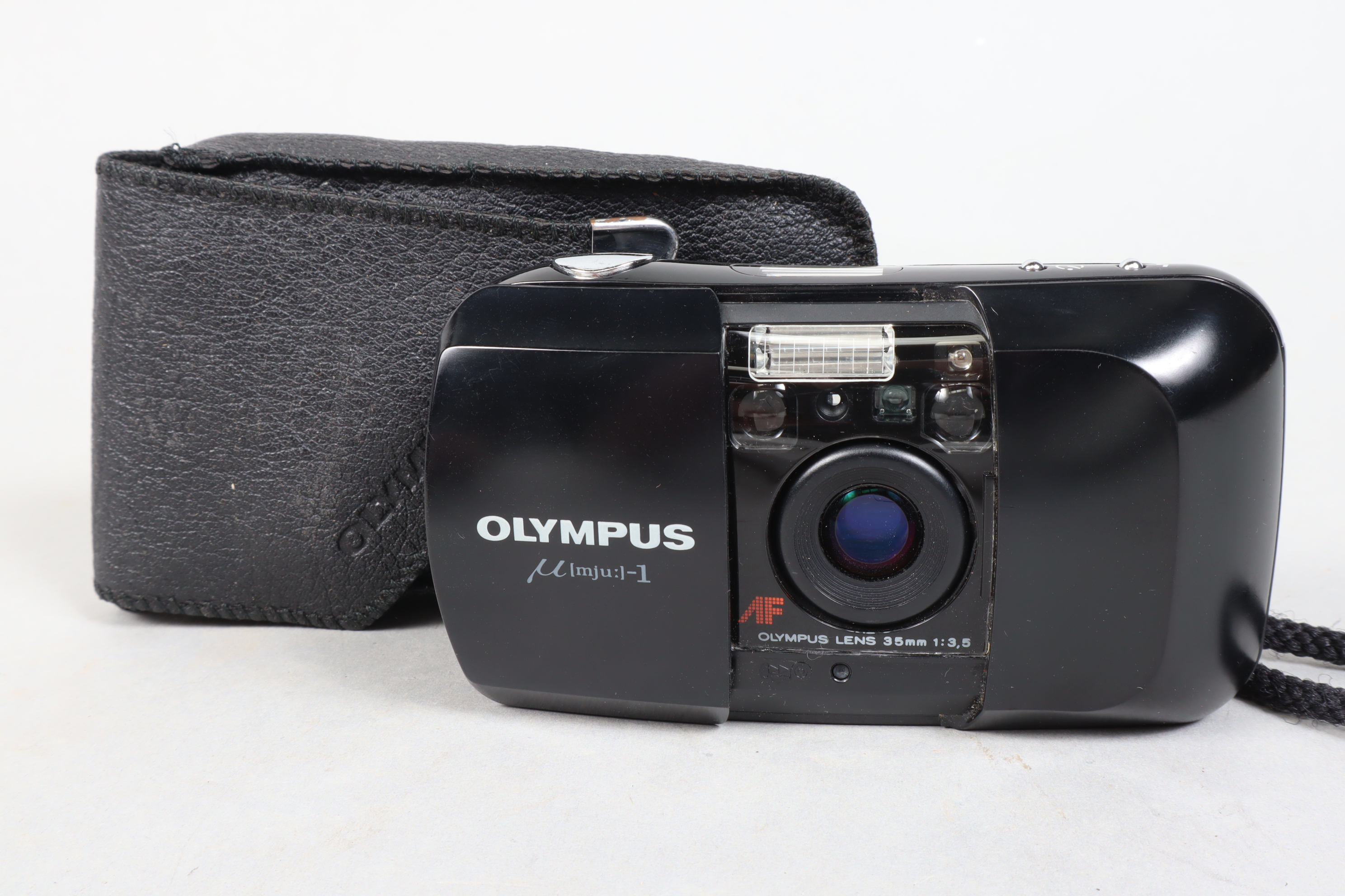 An Olympus mju-1 Compact Camera, black, serial no 5446776, an Olympus 35mm f/3.5 lens, powers up,