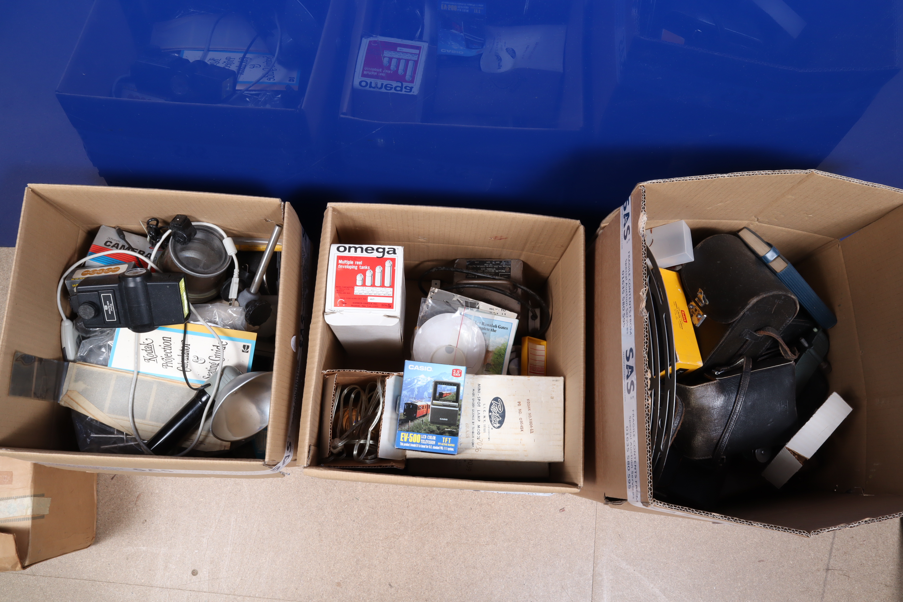 Three Boxes of Camera Related Accessories, including Omega, Nikkor steel developing tanks, other