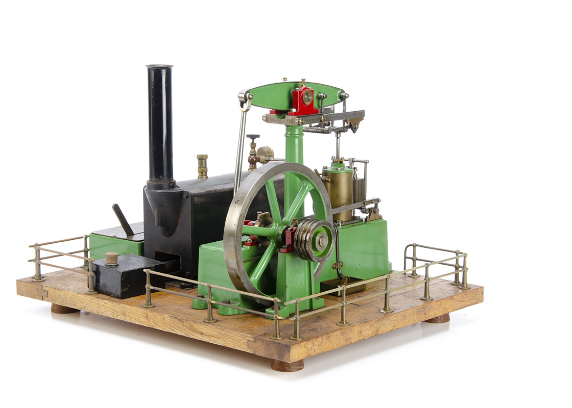 A complete Stuart Turner spirit-fired operating Steam Beam Engine, mounted on a wooden plinth with a