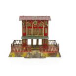 An uncommon Issmayer 0 Gauge two-storey Station, on raised plinth approx 9" x 7" with crimson