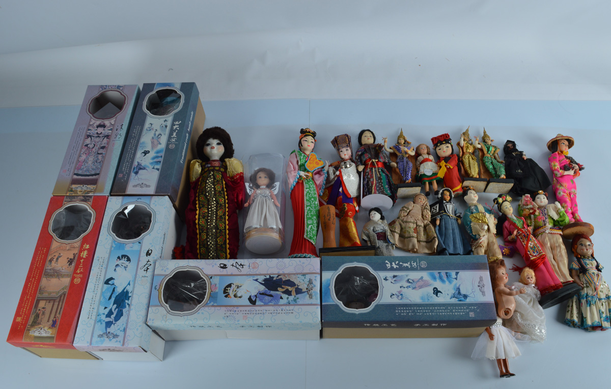 A collection of costume dolls, from around the world, including boxed Japanese and Chinese examples