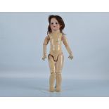 An S.F.B.J 60 child doll, with blue sleeping eyes, brown hair wig, jointed papier mache body and
