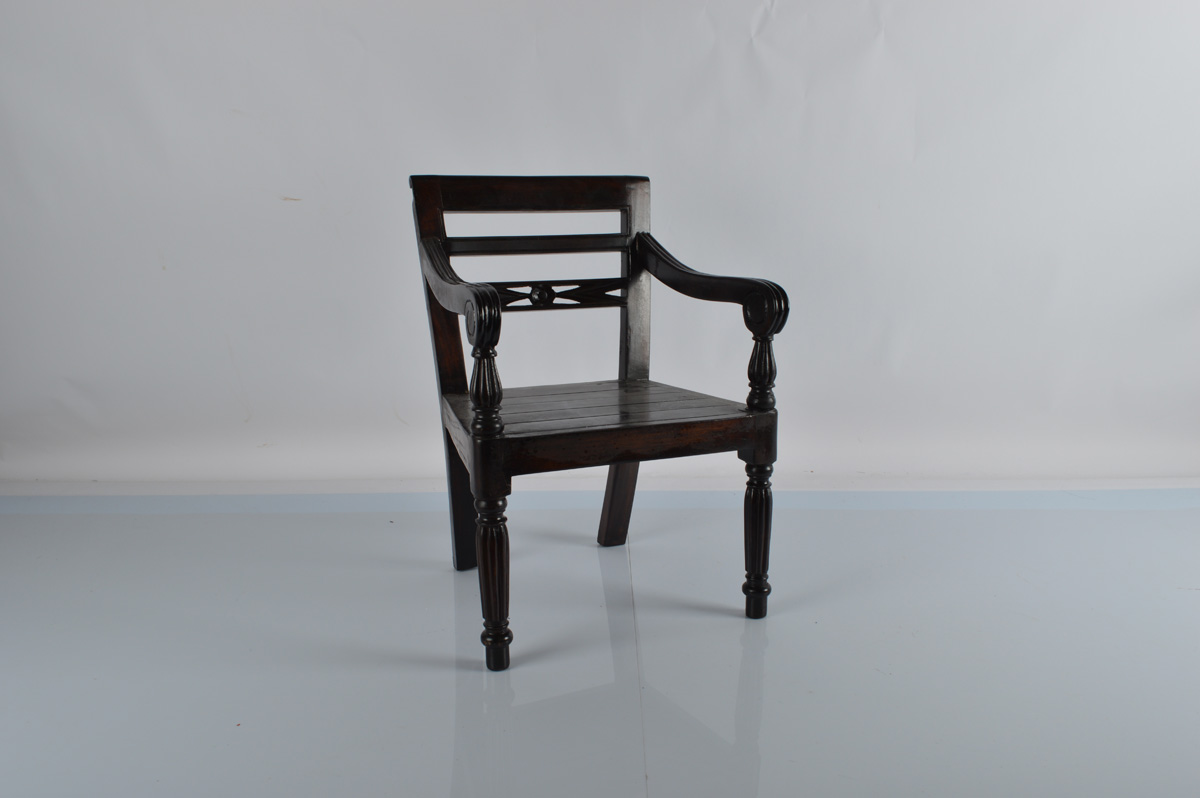 A William IV reproduction child's chair, with plain back rest with carved central flower motif, on a