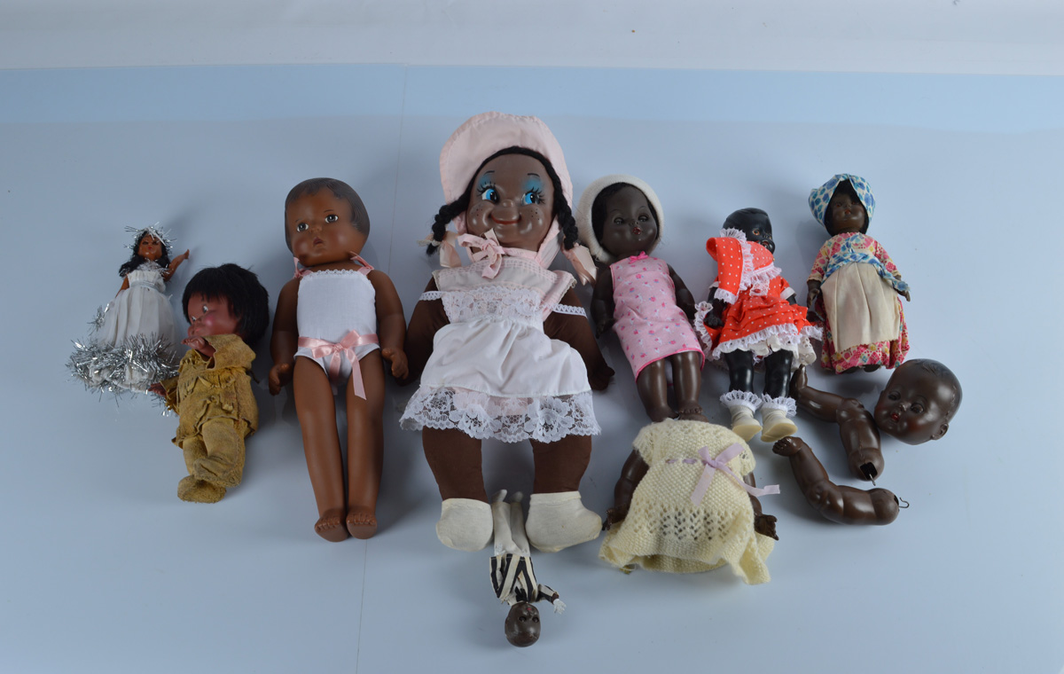 A collection of black child and baby dolls, including a vinyl and plastic example of an American