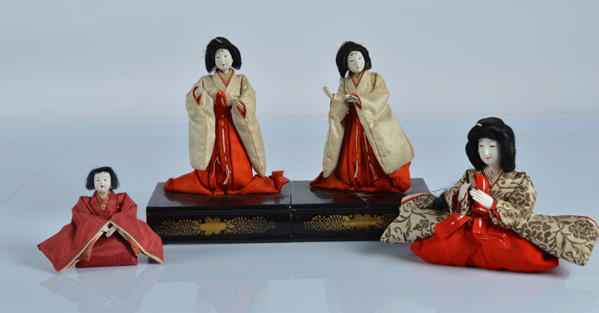 Four Japanese gofun girls festival dolls, on lacquered stands, 7 inch (18cm) overall height and