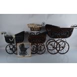 Five contemporary ratan Edwardian style doll prams, in brown, black with wirework scroll supports