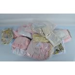 Two boxes of dolls clothing, including various lace shawls